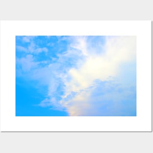 View of the sky split between puffy and thick clouds on the right and azure color on the left Posters and Art